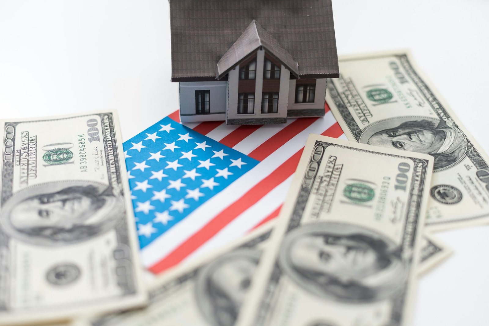 House symbol on American flag. Mortgage credit lending. Housing safety.