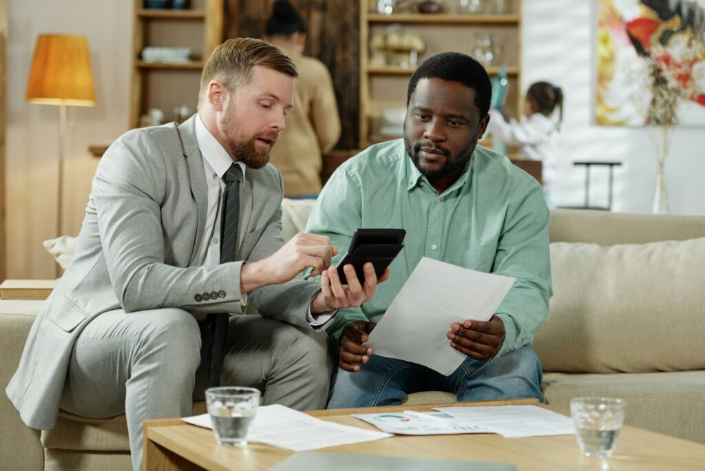 Man with adviser calculating mortgage rate